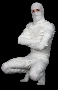 Man in costume of mummy on the black background