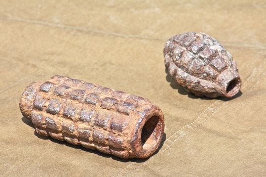 Old defused World War II high-explosive shells lying on the tarpaulin