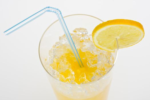 glass of orange juice with lemon slice and straw