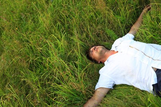 Adult the man weakening in a grass