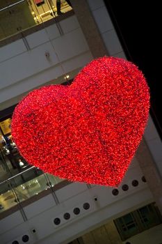 heart shaped light hanging on a shopping mall ceiling