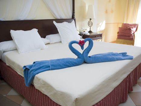 swans made of towels on a hotel bed