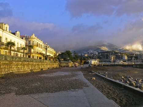 Sunlit houses and mountains under the blue sky