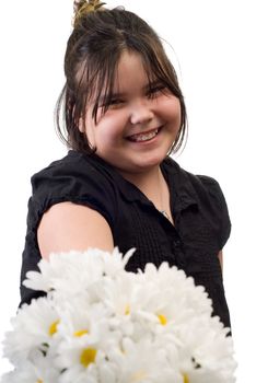 A young girl holding out a bouquet of silk daisies out for Mother's Day, isolated against a white background