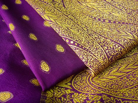 A purple saree with embroidery folded