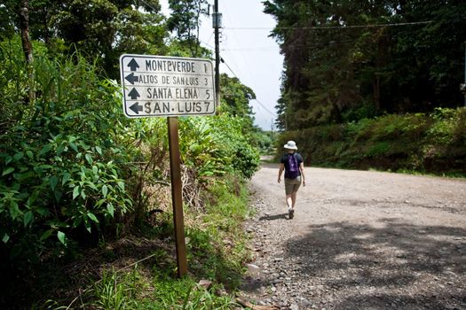 Hiker near sign at intersection in Santa Elena Costa Rica