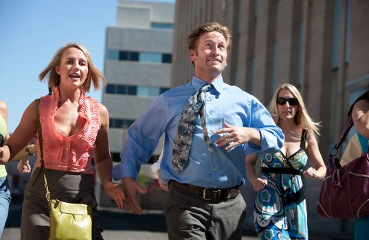 Man races ahead of women in the city.