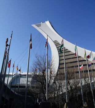 Picture of the Montreal Olympic Stadium tower and flags