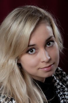 Portrait of the young beautiful girl on a dark background