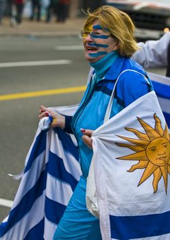 MONTEVIDEO - JULY 02: Urugayan fun celebrating the first semifinals in 40 years after beating Ghana on 2010 world cup on July 02, 2010 in Montevideo, Uruguay 