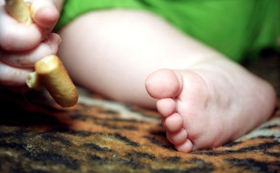 Infant foot and hand fingers with cracknel close up