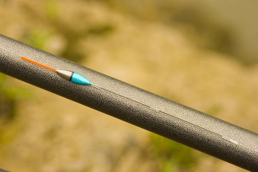 a float on a fishing rod waiting to fish