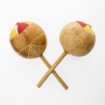 Pair of handmade Mexican maracas percussion musical instruments against white background.