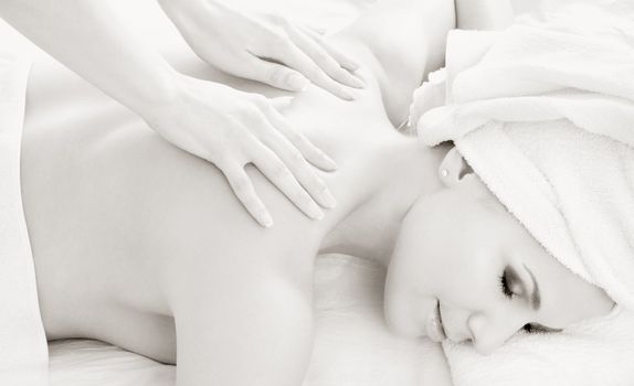 monochrome picture of lovely lady relaxing in massage salon