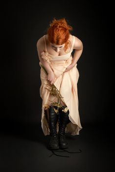 dark picture of surreal bridesmaid with dead flowers