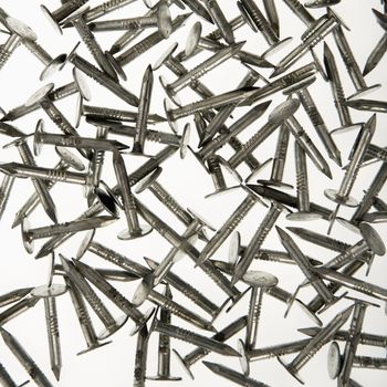 Pile of nails against white background.