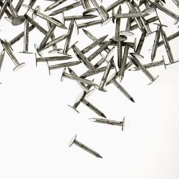 Pile of nails against white background.