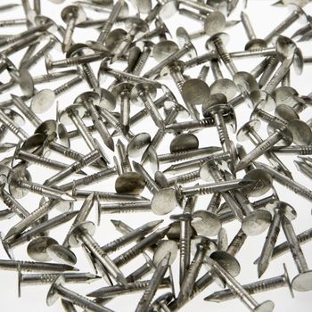 Pile of nails against white background.