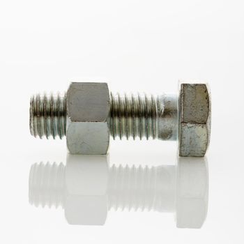 Nut and bolt against white background.