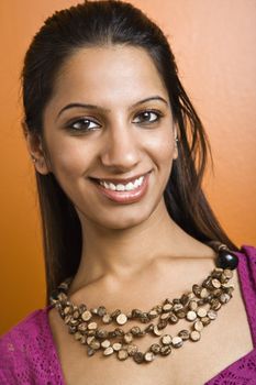 Attractive young adult Indian woman smiling at viewer.