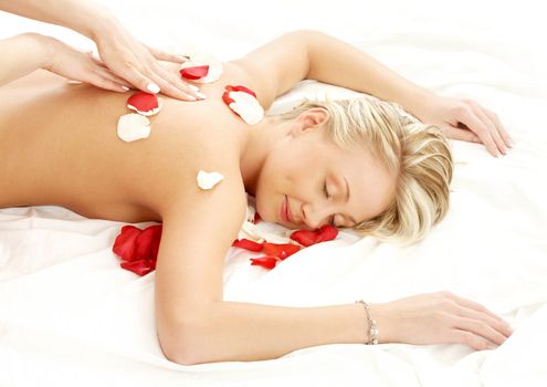 picture of lovely lady with flower petals in massage salon