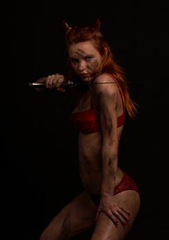 dark red devil girl with a knife over black