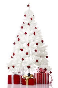 Christmas white tree and gifts over a white background