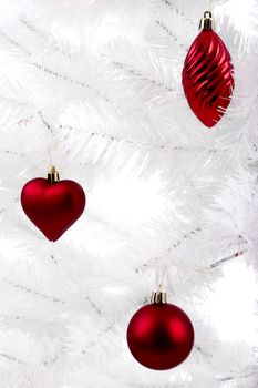 Christmas ornaments hanging from a white tree