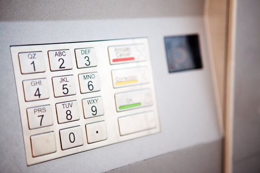 A close up detail of an outdoor bank machine; shallow depth of field with critical focus on middle row of numbers