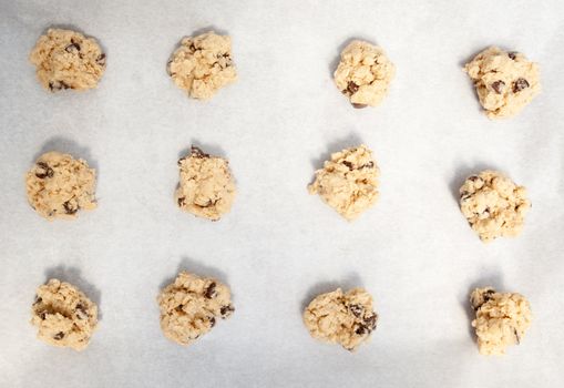 Cookie dough on a cookie sheet with baking paper