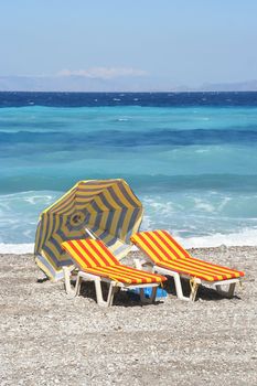 Beach chairs and parasol on a Mediterranean beach