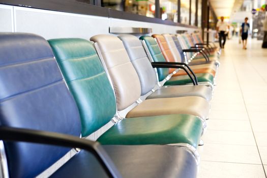 An empty interior of an airport with out of focus people in the background