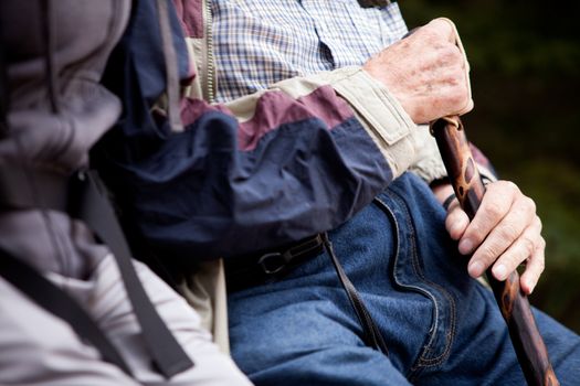 Detail of an elderly man with walking stick