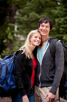 A young man and woman outdoors in the forest