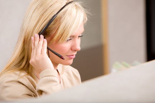 A receptionist talking on the phone with a headset