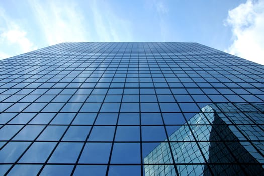 A upward perspective of two very modern skyscrapers