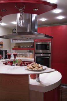 Red modern kitchen. Interiors. Cupboard. Table top.