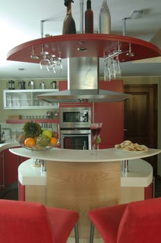 Red modern kitchen. Interiors. Cupboard. Table top.