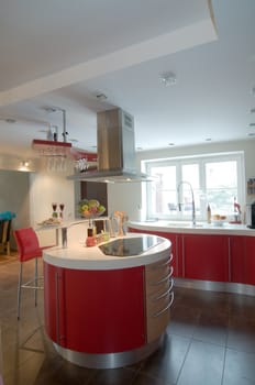 Red modern kitchen. Interiors. Cupboard. Table top.