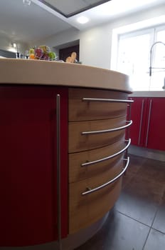Red modern kitchen. Interiors. Cupboard. Table top.