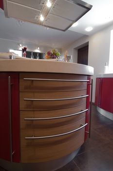 Red modern kitchen. Interiors. Cupboard. Table top.