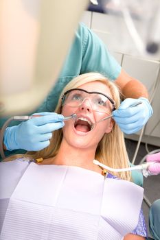 A patient at the dentist having their teeth worked on