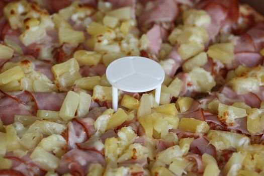 Close up of a Hawaiian Pizza.