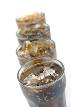 Glasses of cola isolated against a white background