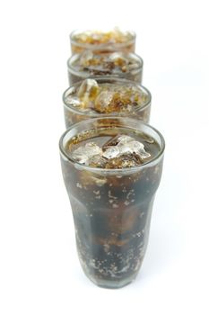 Glasses of cola isolated against a white background