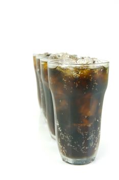 Glasses of cola isolated against a white background