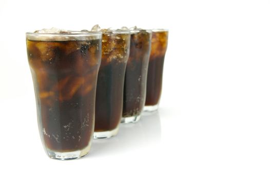 Glasses of cola isolated against a white background