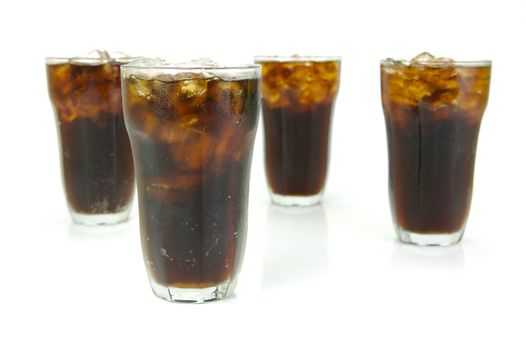 Glasses of cola isolated against a white background