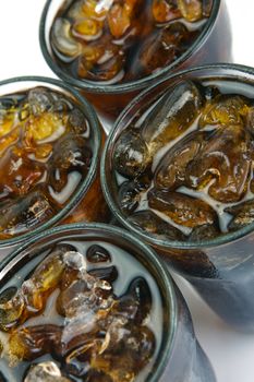 Glasses of cola isolated against a white background