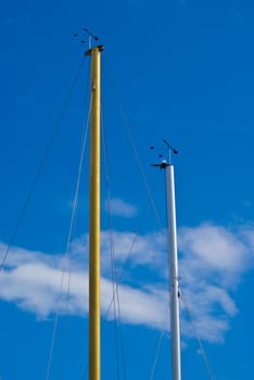 A pair of masts on a sunny summer day.